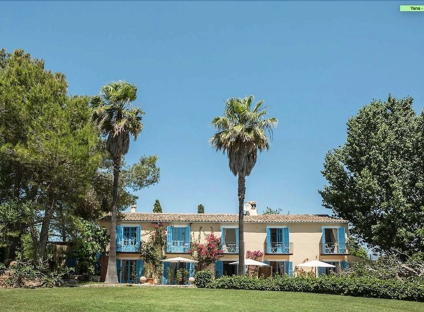 Bungalow country house in Spain with towering trees outside