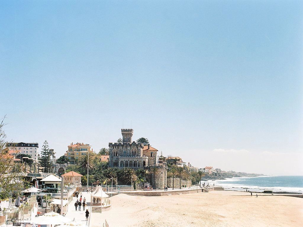 A seaside medieval castle in Portugal with neighboring buildings and castles