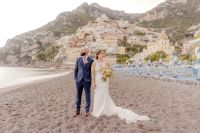 Bride and groom posing on the beach in Positano for their elopement in Italy