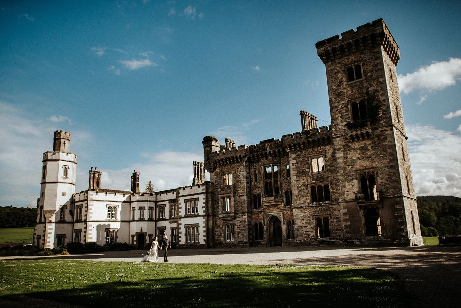 A medieval castle with a castle ruin beside it - a venue for destination weddings in Ireland