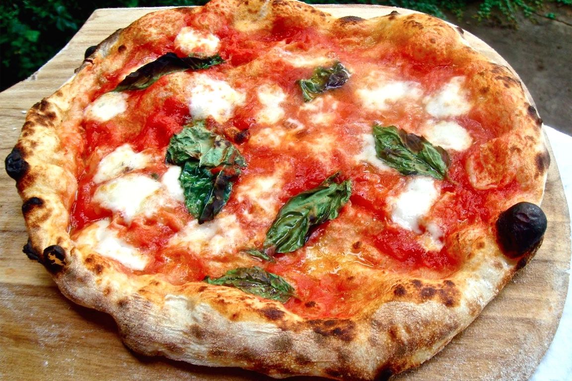 Close-up shot of a whole Margherita pizza