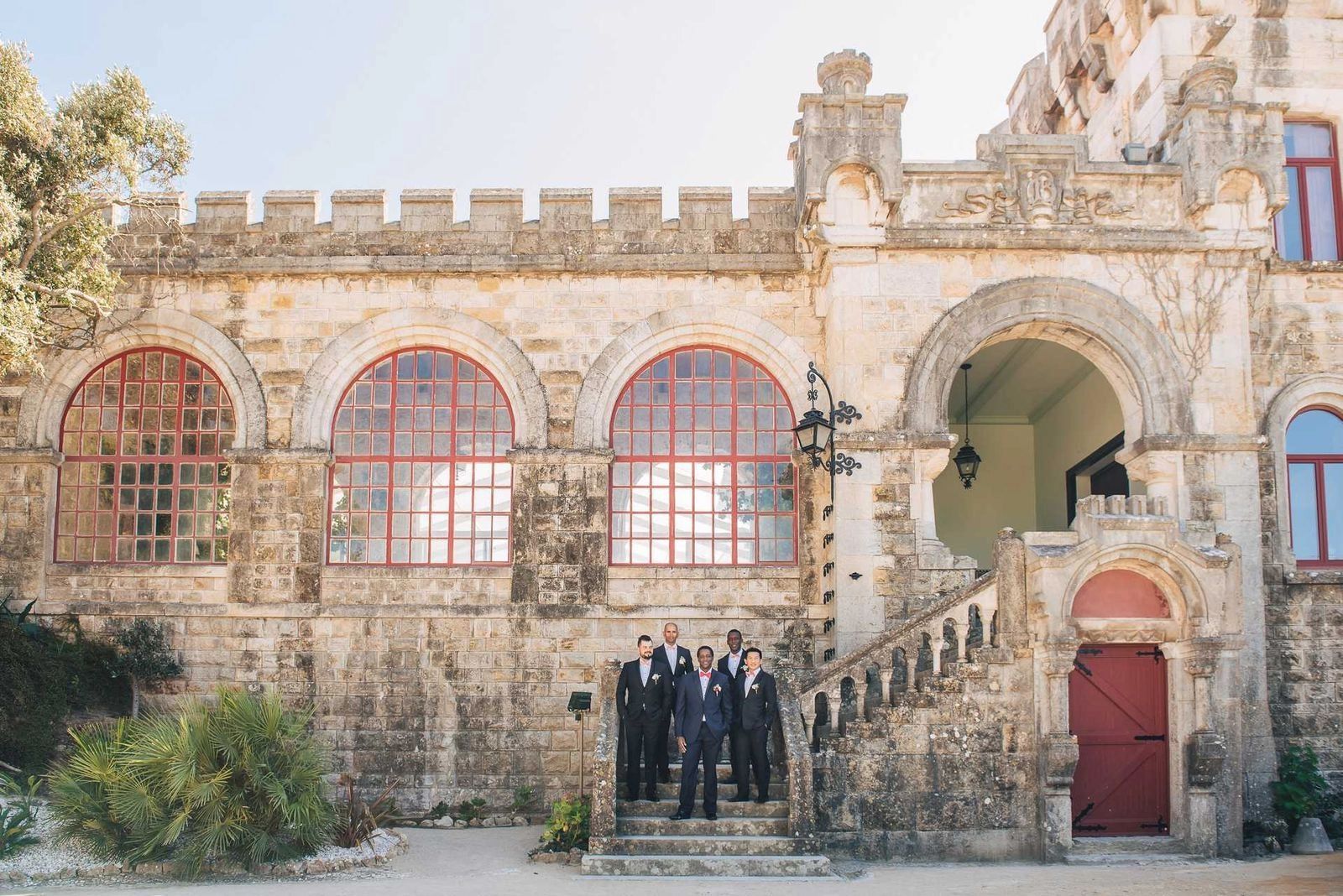 Groom and his groomsmen having a photoshoot in front of a medieval castle in Portugal