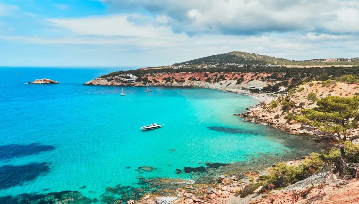 Ibiza shores with turquoise waters on a bright warm sunny day.
