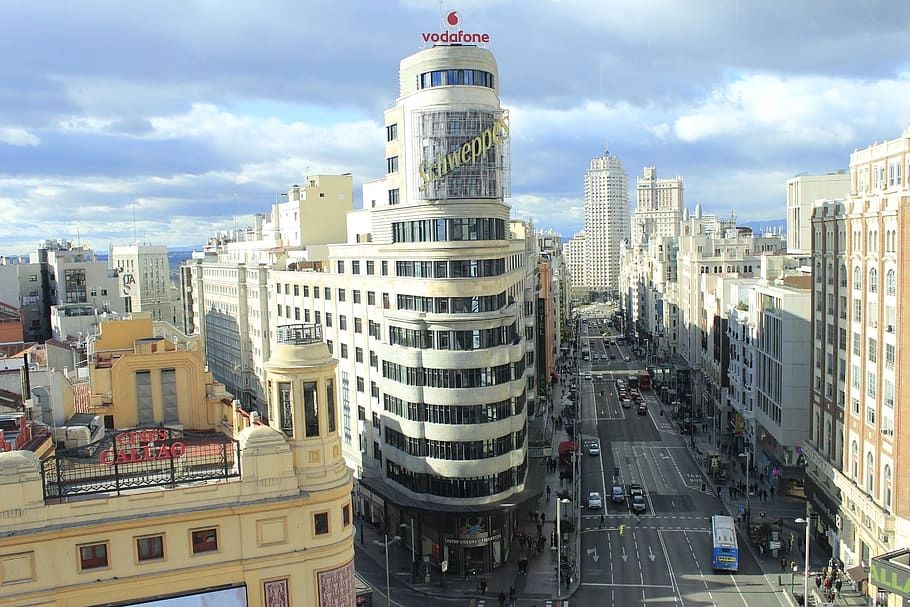 Madrid’s main square with tall modern buildings and busy roads on a bright sunny day