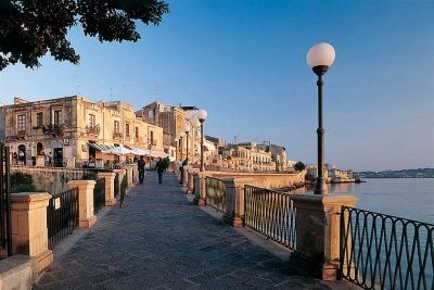 Sicily’s streets with ancient buildings and the sea next to the village