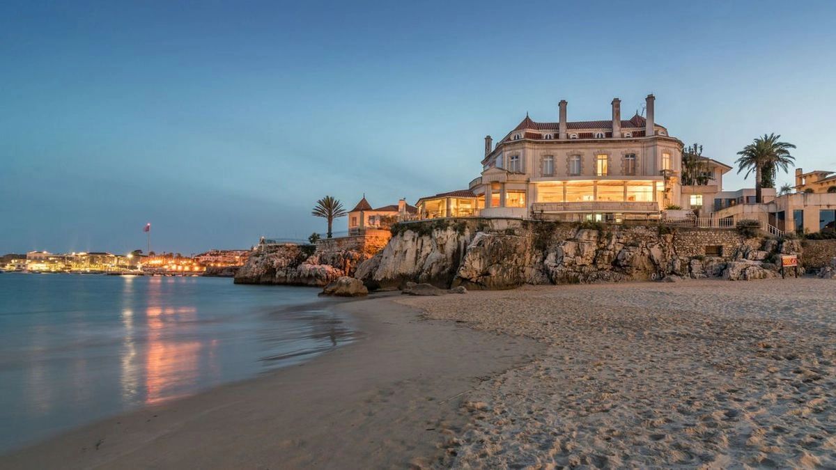 Palace hotel by the ocean during sunset in a coastal location in Portugal