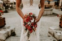 Cascading red lilies as bridal bouquet for an elopement in Europe