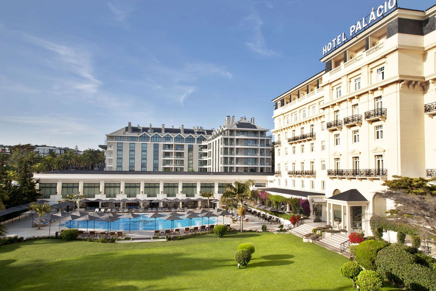 Classic white palace hotel with gardens and a pool in Cascais for destination weddings in Portugal