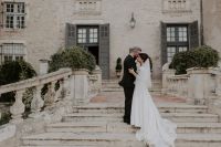 Couple hugging each other on a staircase of a chateau during their wedding in France.
