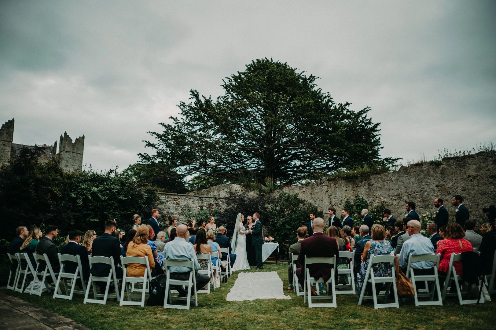 Bride and groom holding hands in the middle of the ceremony of their small wedding in Ireland.