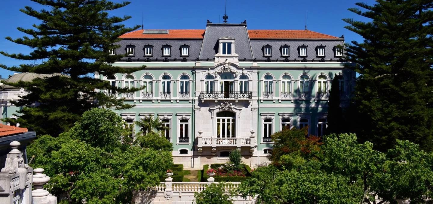 Light blue palace hotel surrounded by trees for destination weddings in Portugal