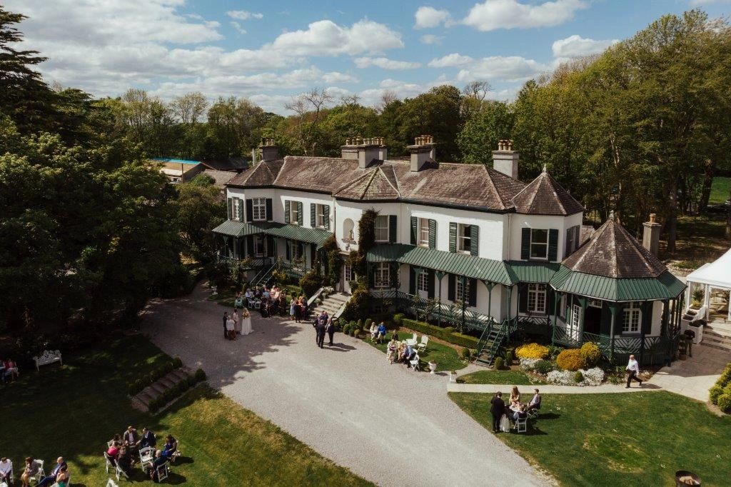 Old country house surrounded by wedding guests in Ireland