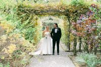 A pathway enclosed by trees with bent branches creating a shade where newlyweds walk during their Irish destination wedding