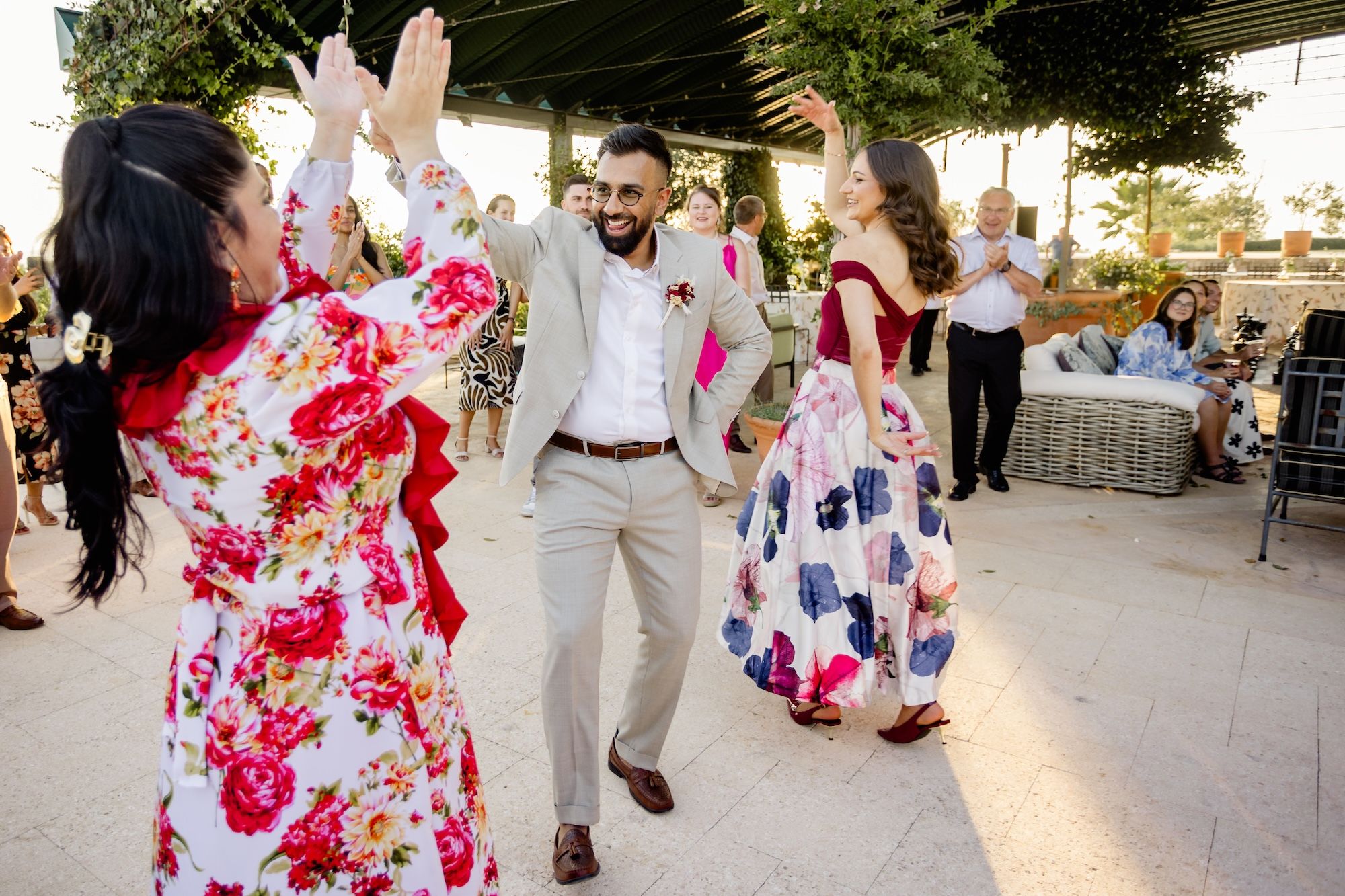 Newlyweds dancing flamenco in semi-formal attire after the ceremony of their small wedding in Spain