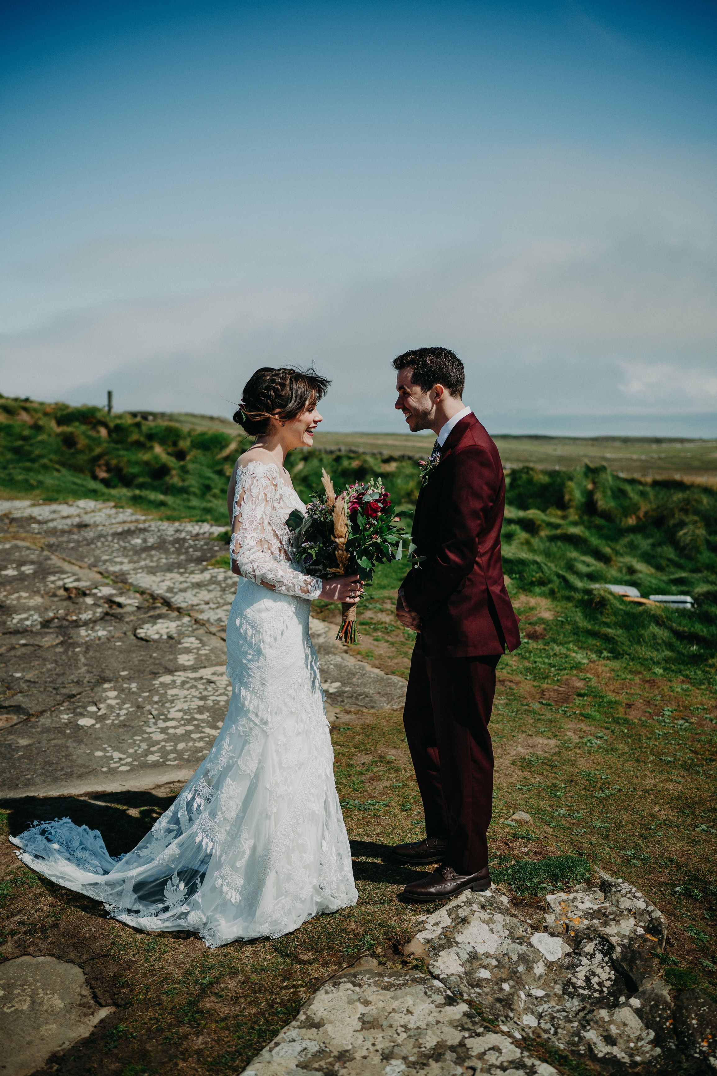 A bride and groom on top of a cliff before their small wedding in Ireland