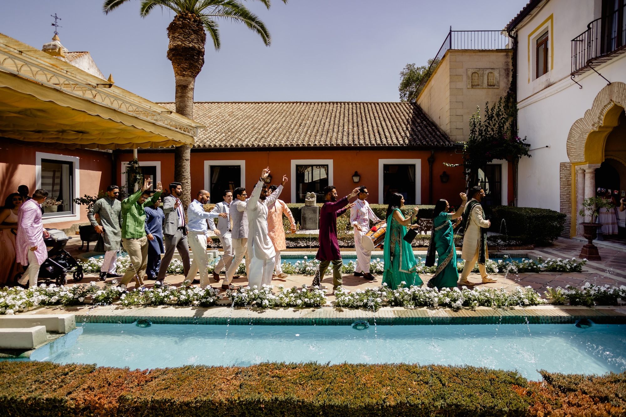 Wedding guests for a destination wedding in Spain dance and celebrate under the warm summer weather