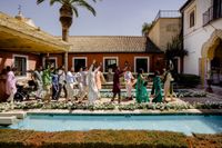 Wedding guests for a destination wedding in Spain dance and celebrate under the warm summer weather