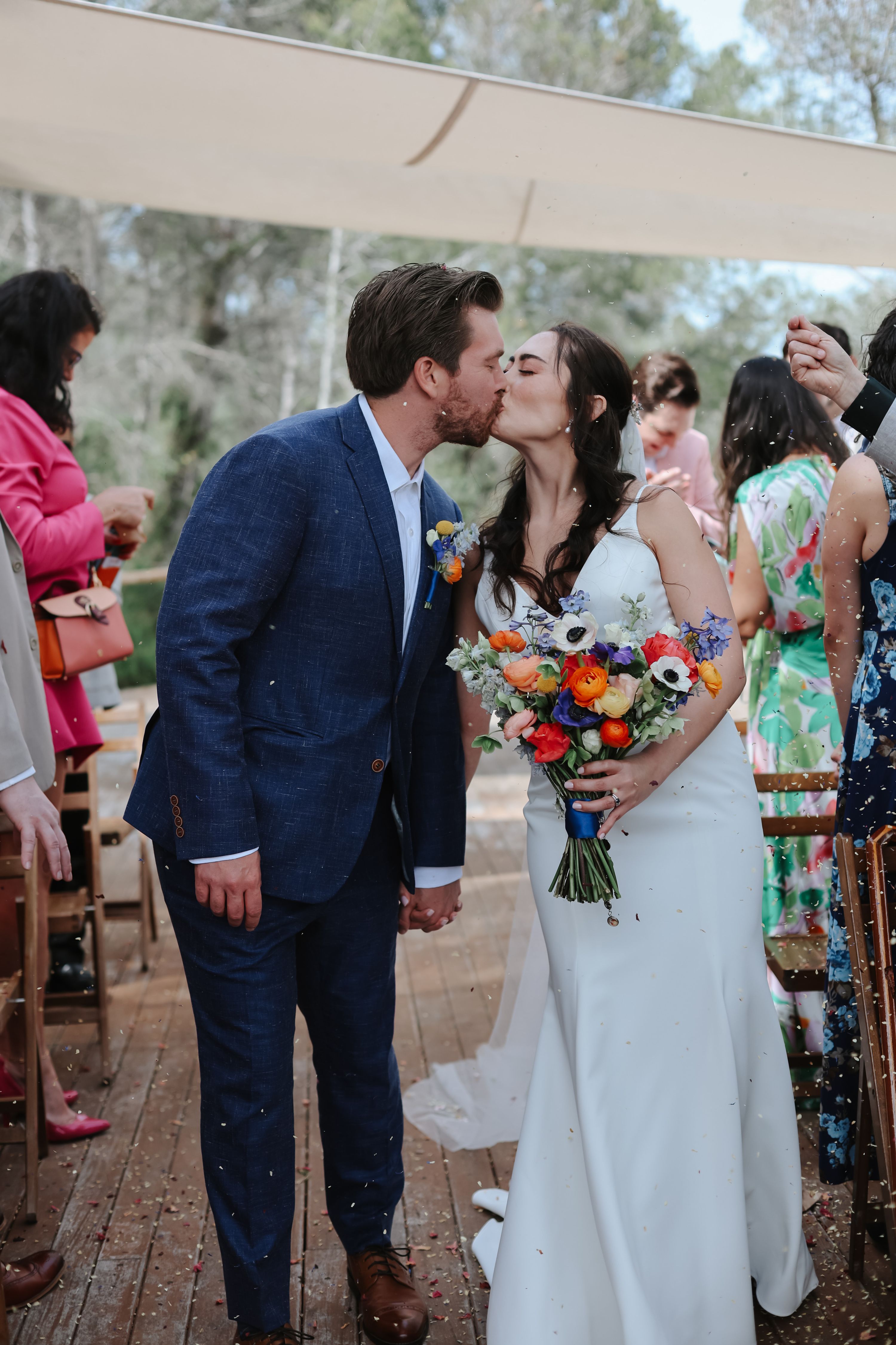 Newlyweds kissing in the middle of the aisle during their destination wedding in Spain