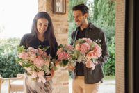 Destination wedding in Italy with the florist holding the bouquets for an intimate wedding in Italy