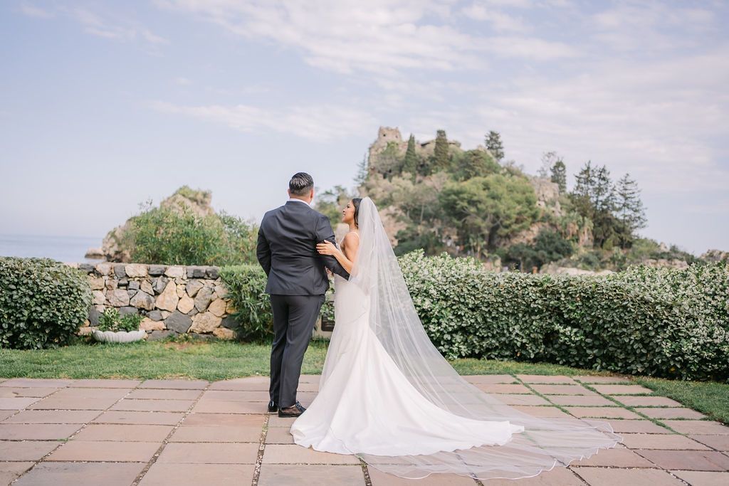 Bride and groom talk and appreciate the beauty of the venue for their vow renewal in Italy