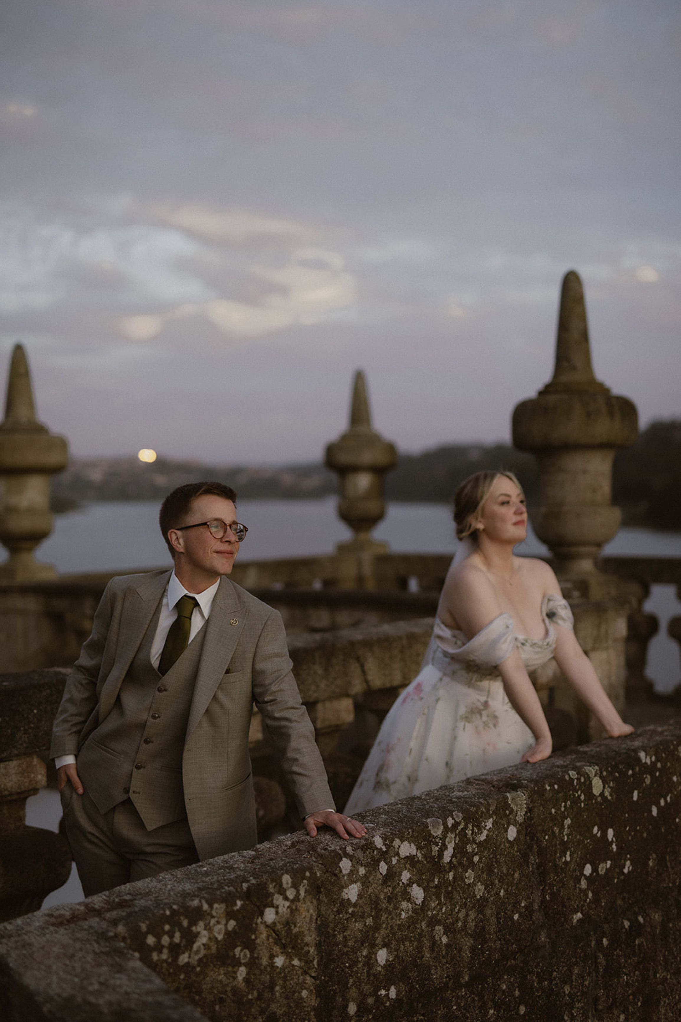 Bride and groom enjoying scenic river views at dusk during a small wedding in Portugal