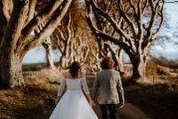 Bride and groom walking though the Dark Hedges, a filmind location for Game of Thrones in Northern Ireland
