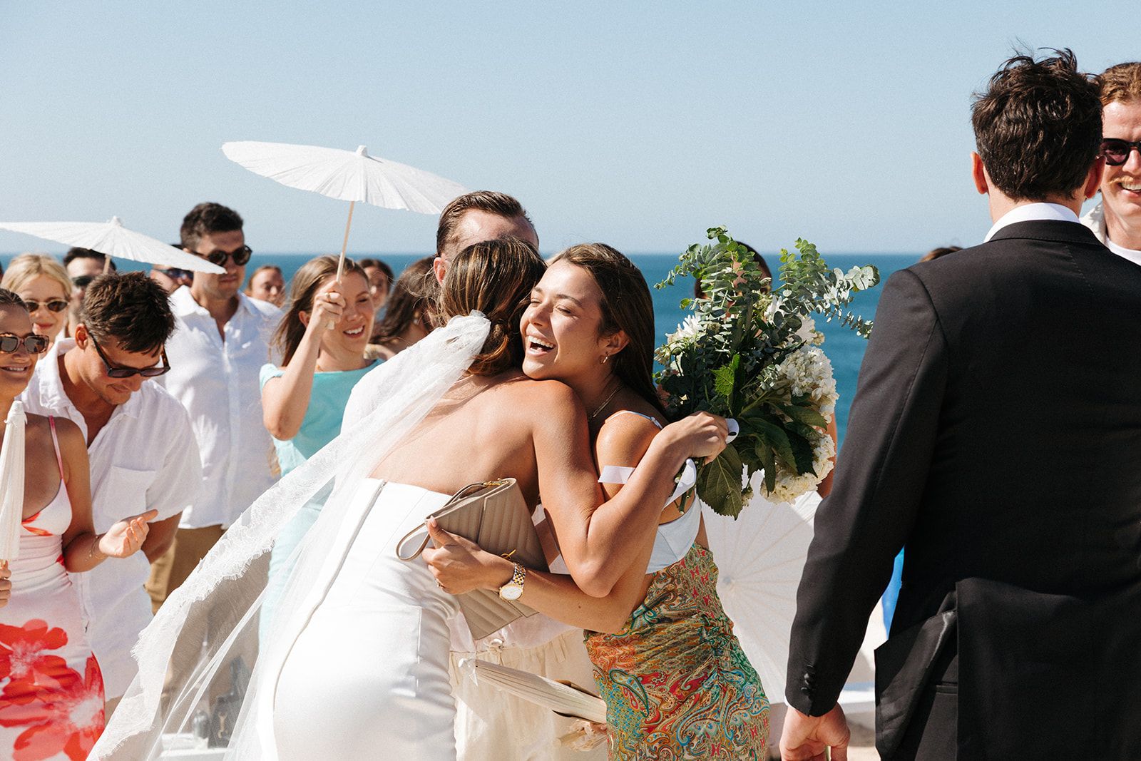Couple having an outdoor ceremony atop the cliffs in Algarve for their destination wedding in Portugal.