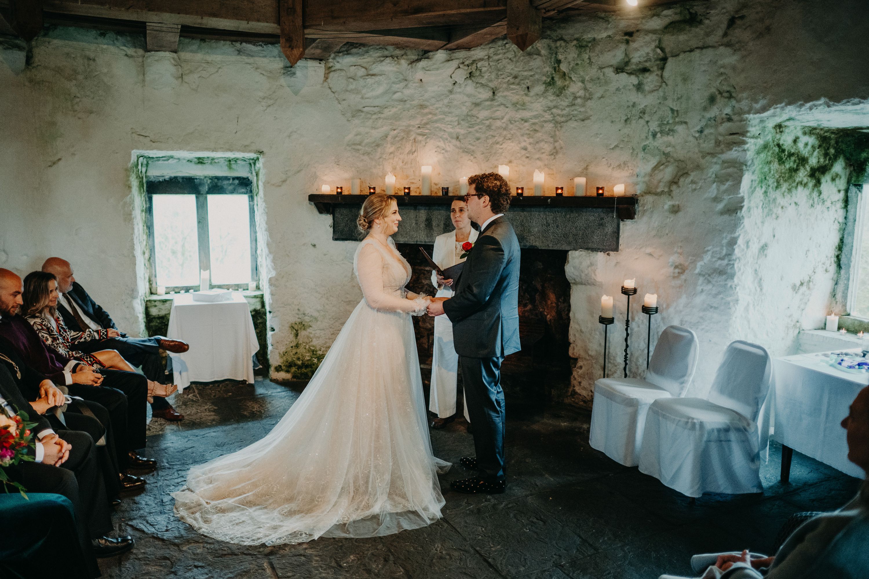 Bride and groom exchanging vows in a historic stone venue for a small wedding in Ireland