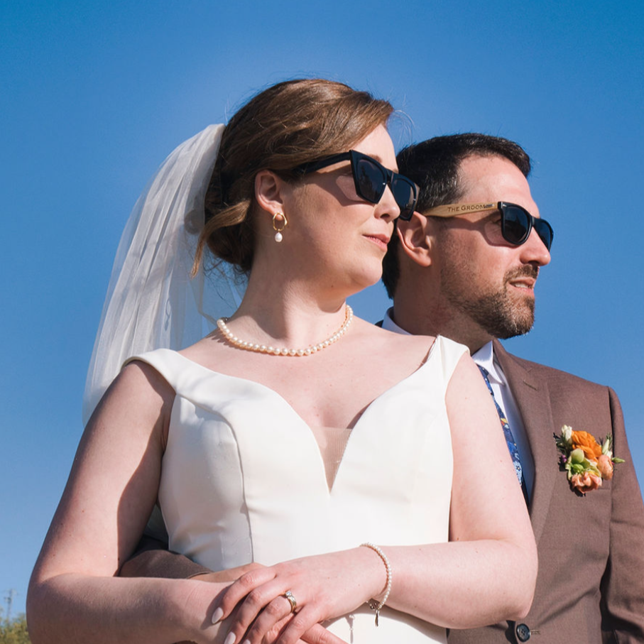 Bride and groom posing in sunglasses at a wedding in Spain
