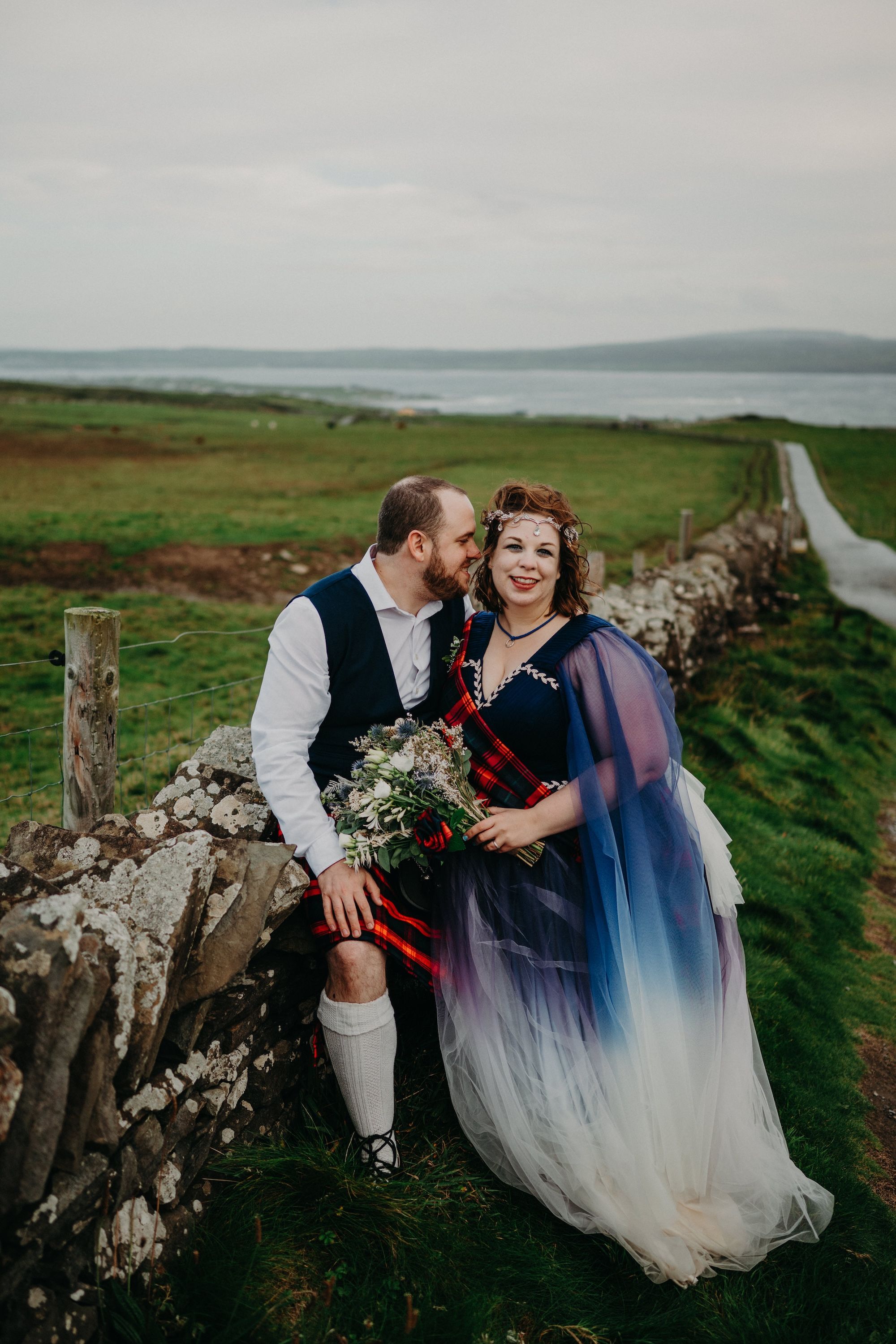 Newlyweds having a light moment during the romantic, outdoor photoshoot of their elopement in Ireland
