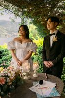 Bride and groom looking at their celebrant during the ceremony of their elopement in Italy at a villa along Lake Como