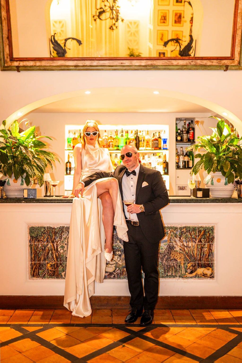 Newlyweds under having a relaxed photoshoot at night before the reception of their vow renewal in Italy