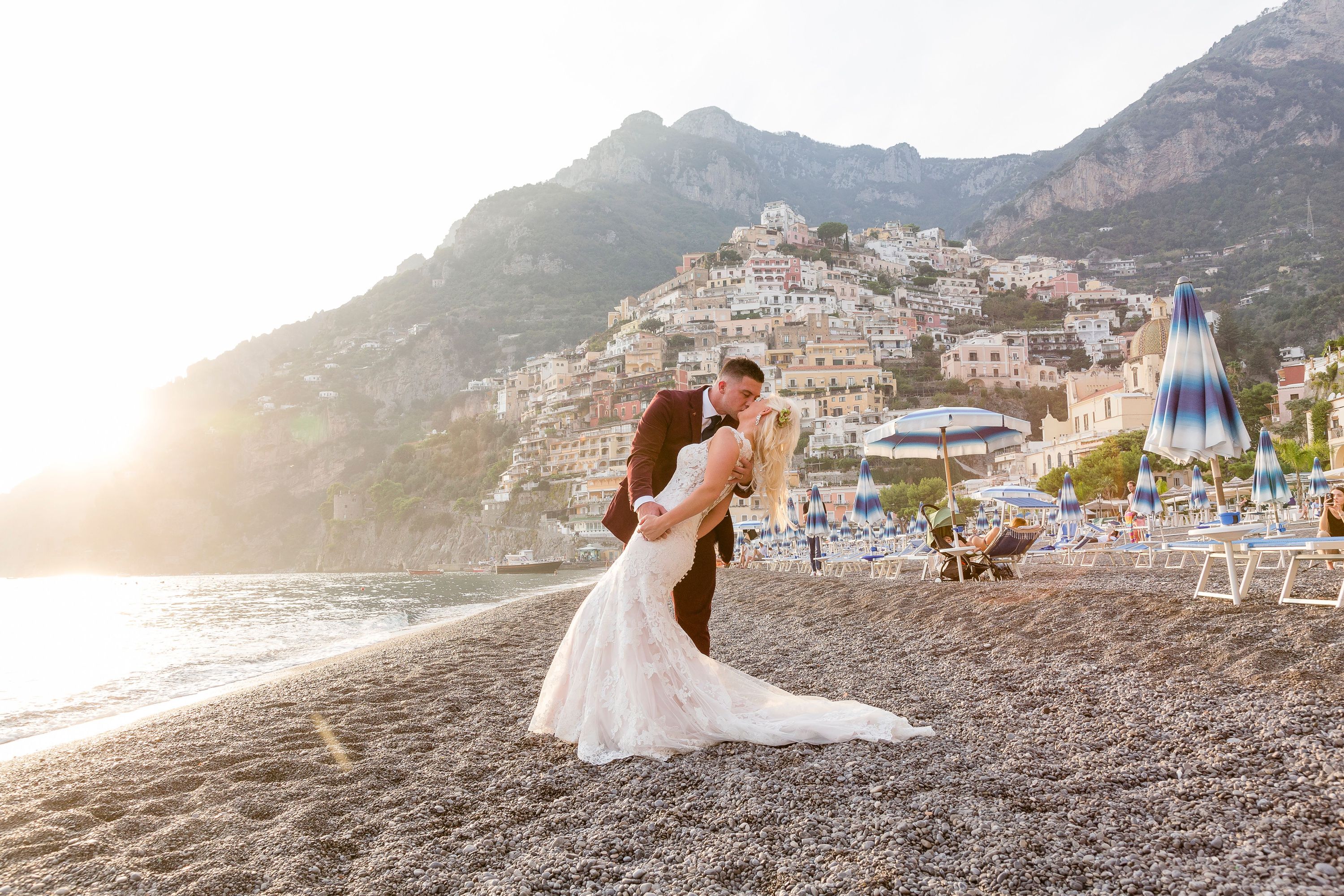 Bride and Groom kissing on a beach in Positano