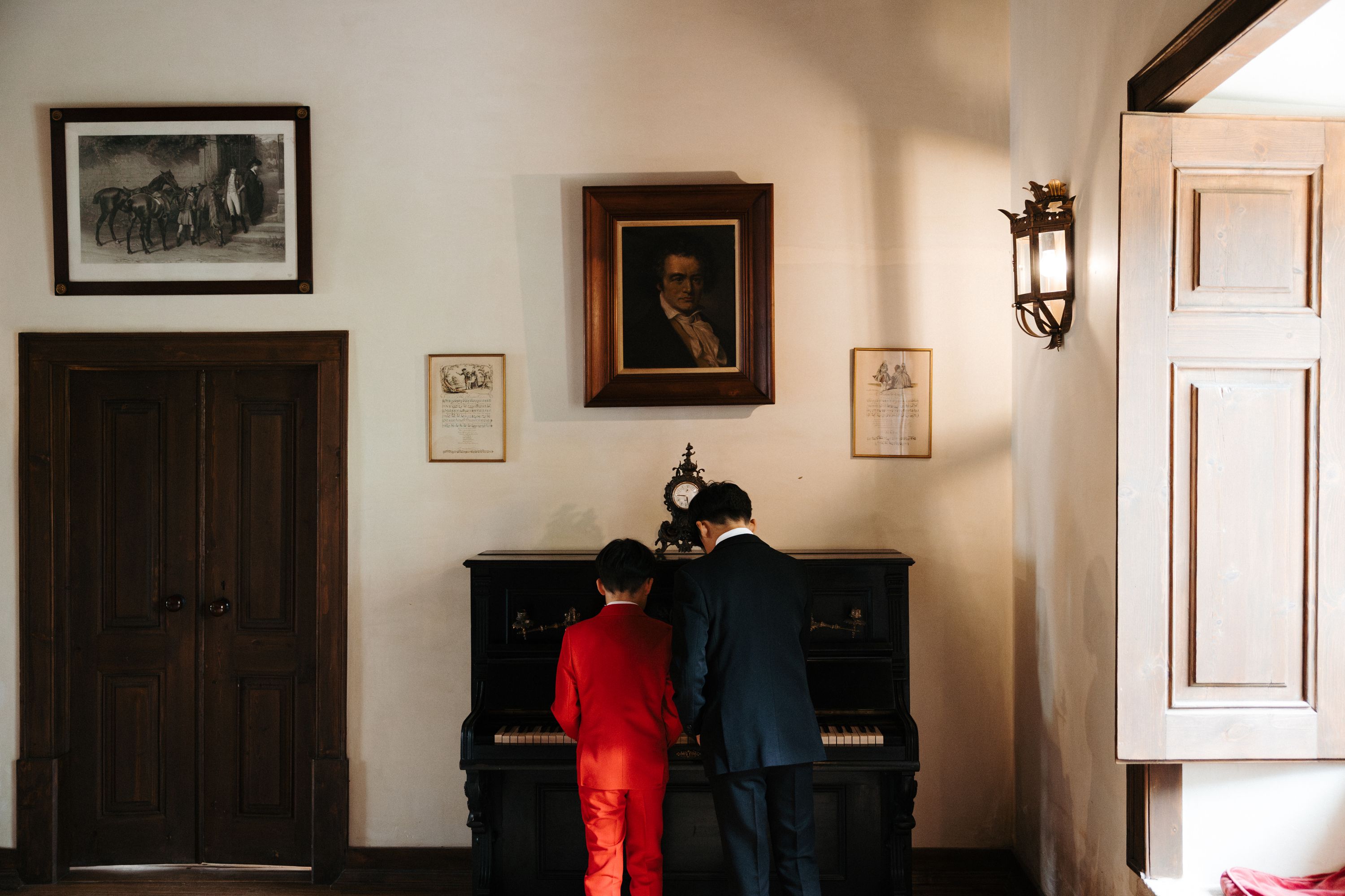 Two children playing the piano in a wedding villa in Portugal
