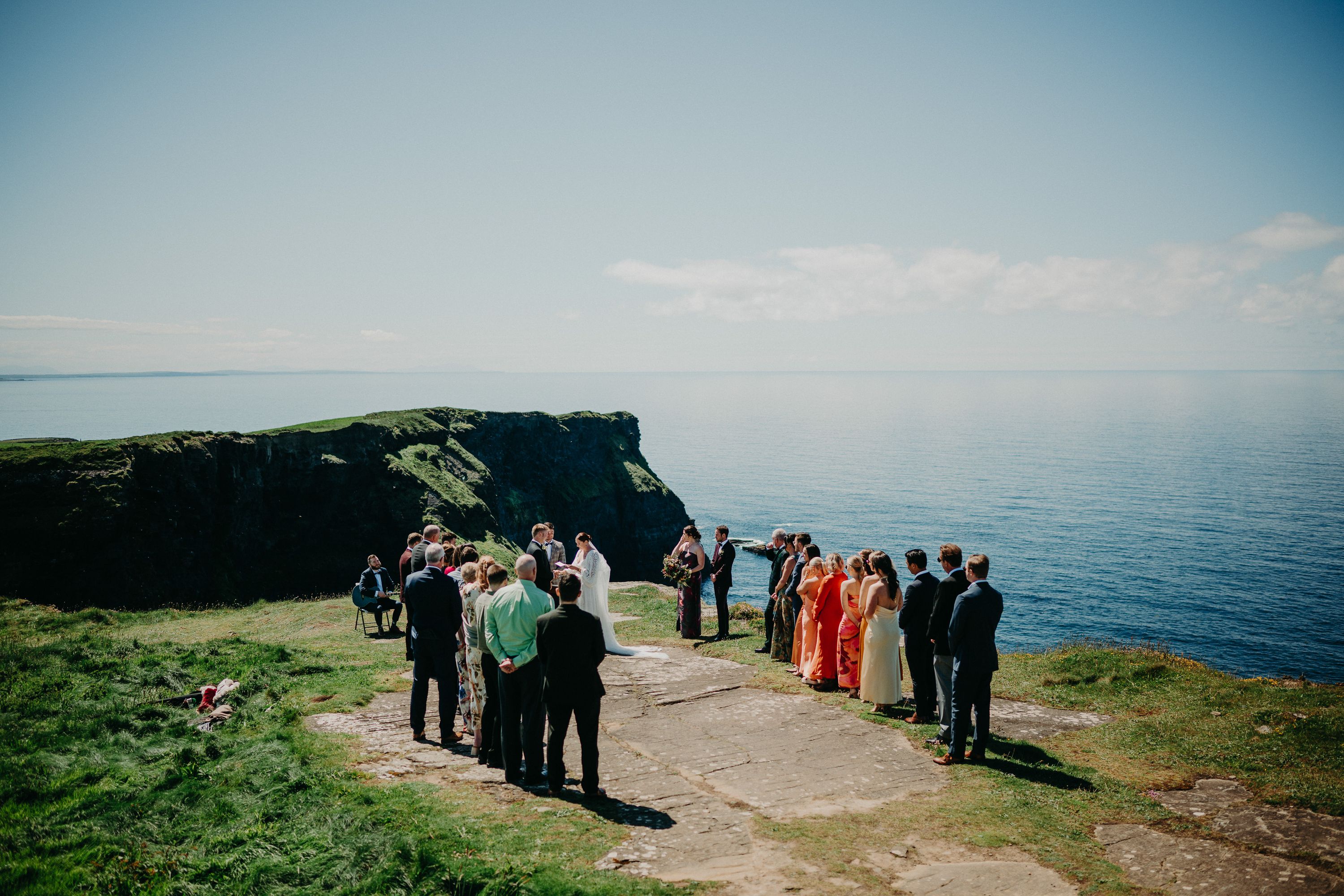 A ceremony held before a groom and bride on top of a beautiful cliff for an intimate wedding in Ireland