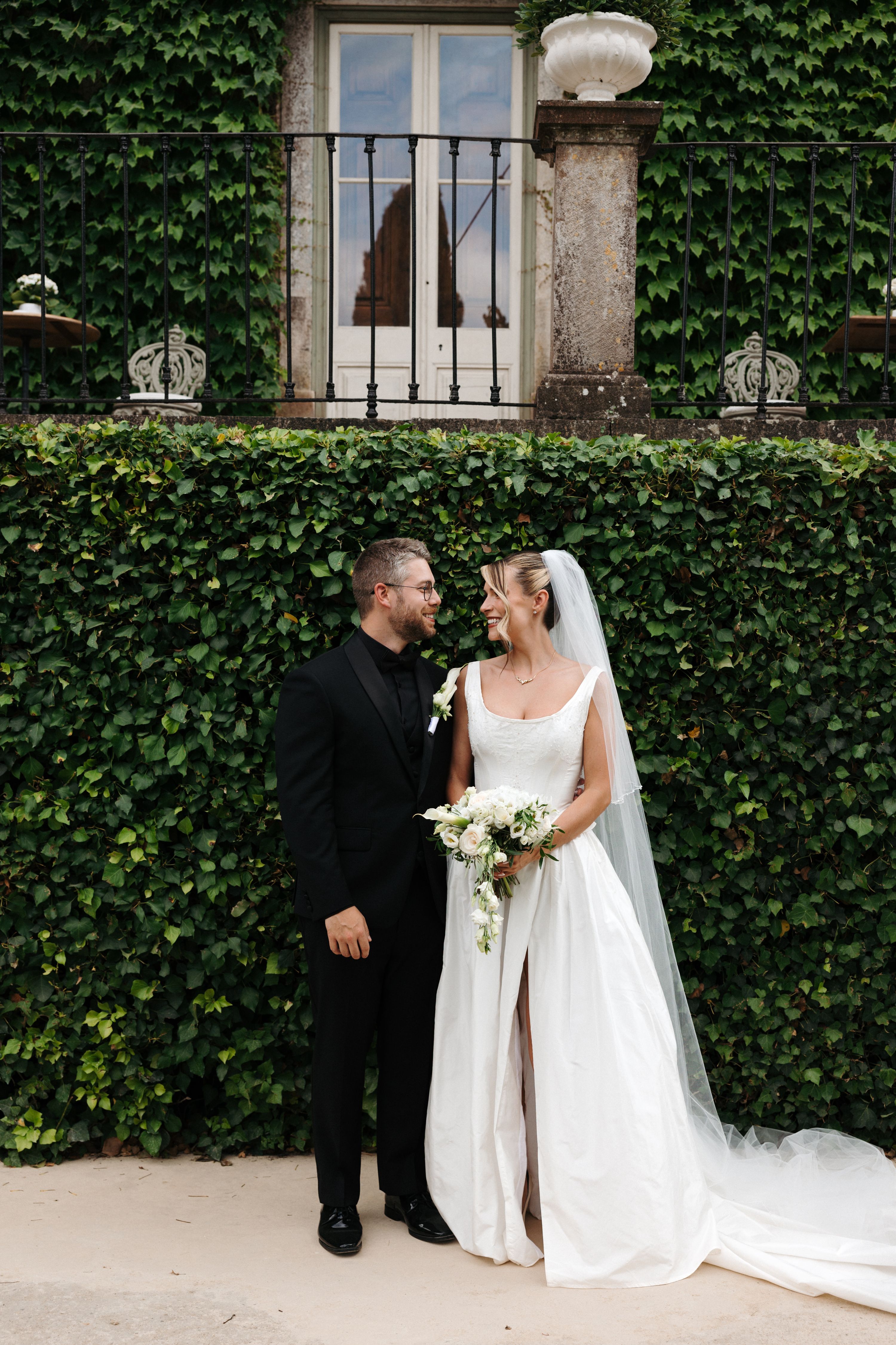 bride and groom looking at each other and smiling happily