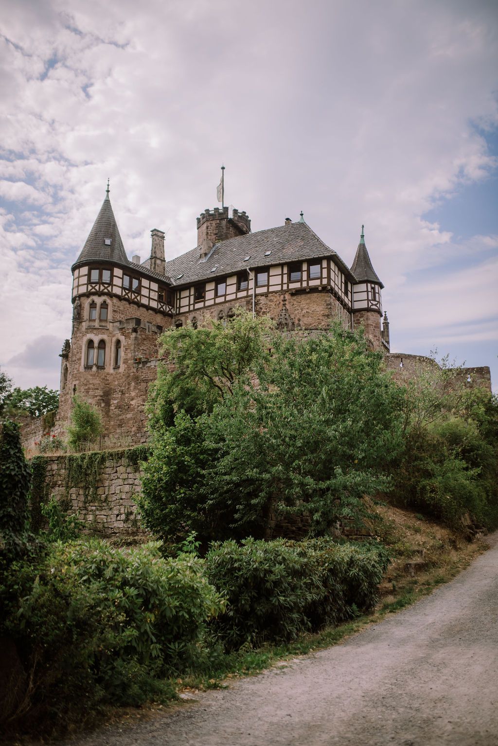 A medieval castle with trees and shrubs set for an intimate wedding in Germany