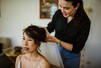 Wedding planner fixing bride's veil at a wedding in Italy