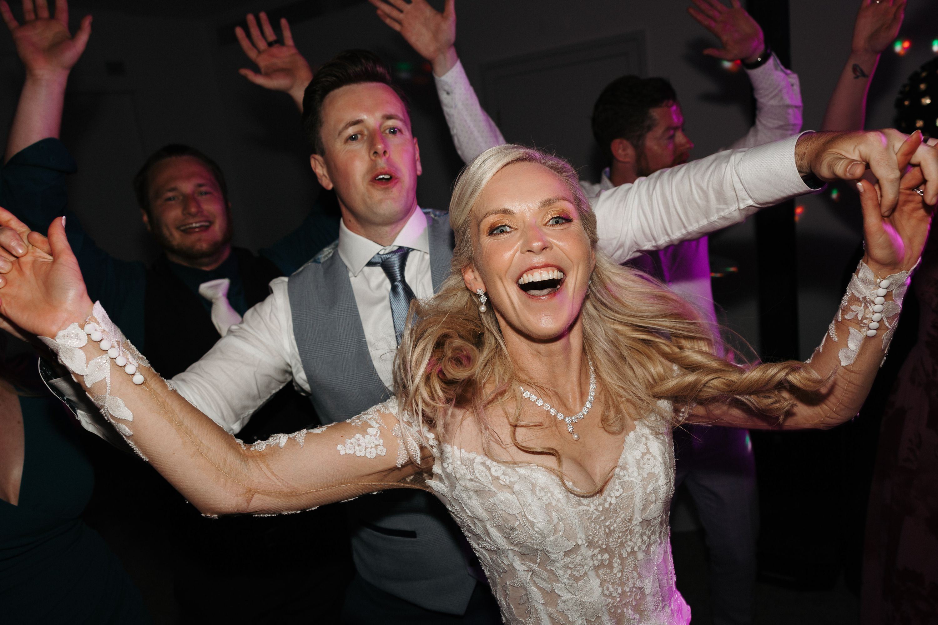 Bride and groom dancing together during a lively small wedding in Portugal reception