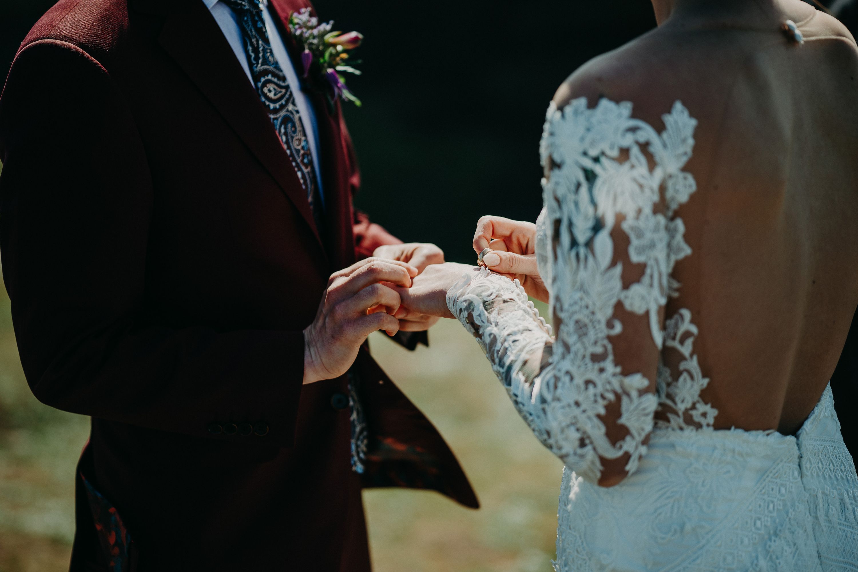 A groom wearing the ring on his bride's finger during their small wedding in Ireland