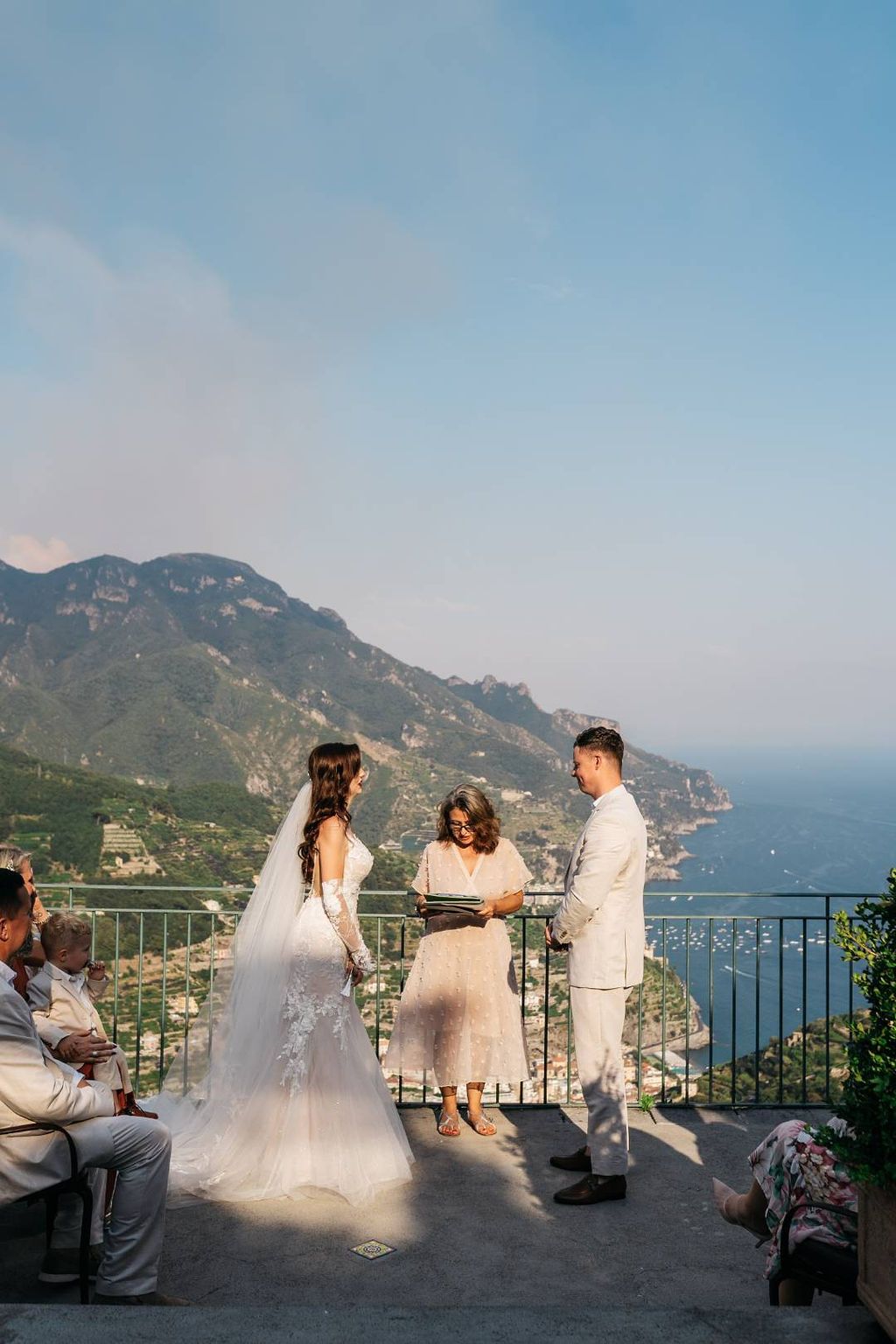 A ceremony of a bride and groom who got married in Italy at the cloister of an ancient villa in Positano