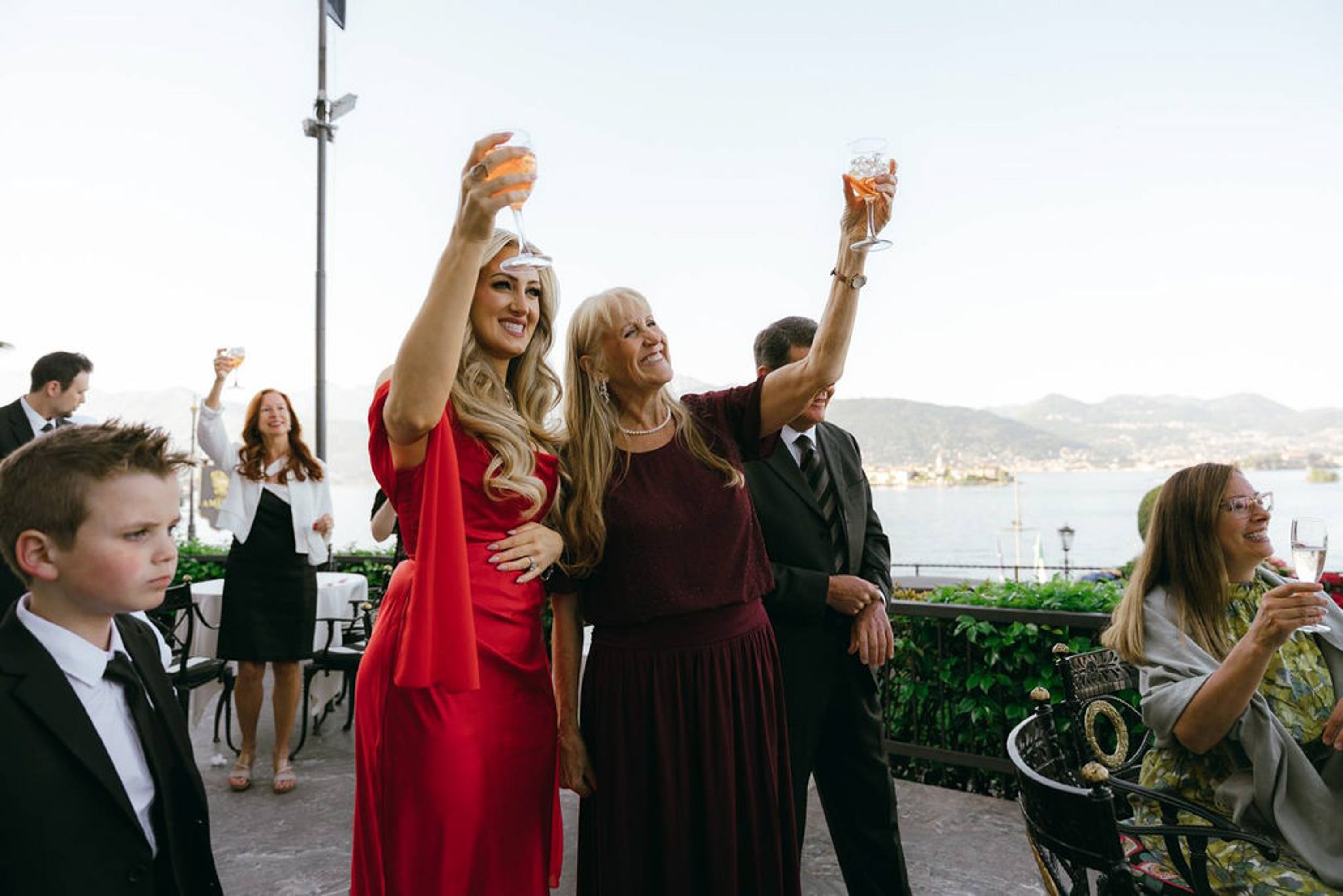 Family and guests raising a toast overlooking the lake at an intimate wedding in Italy