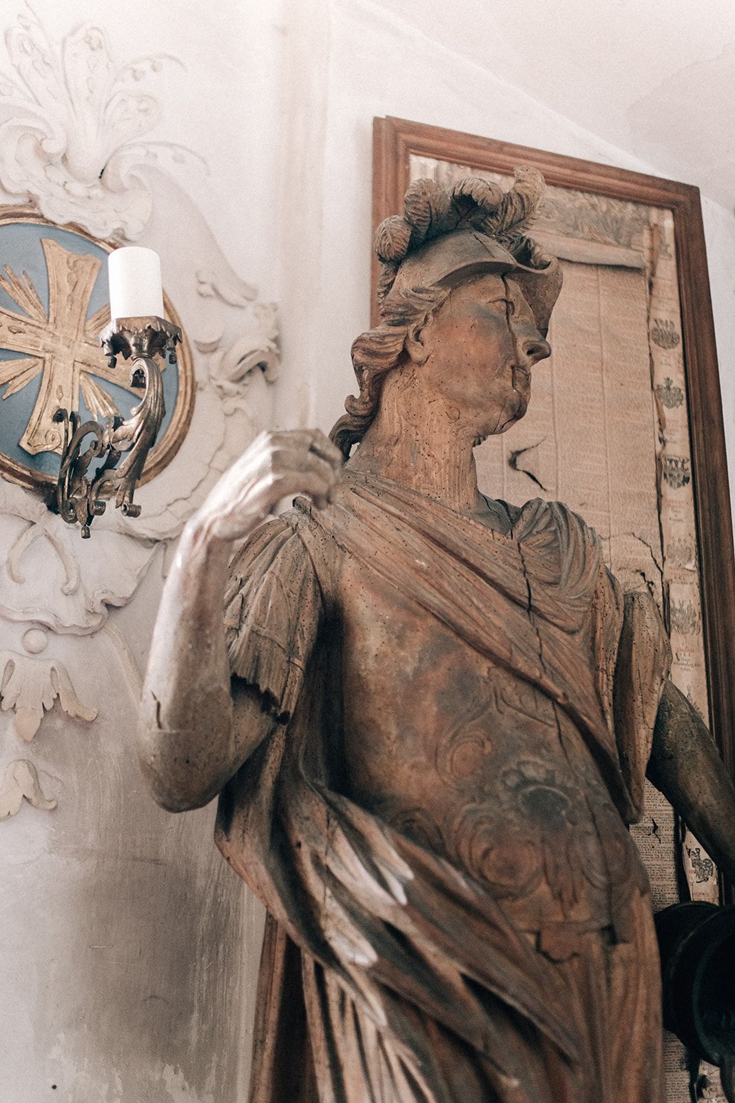 Historic statue and gilt-framed mirror inside a centuries-old Austrian palace venue