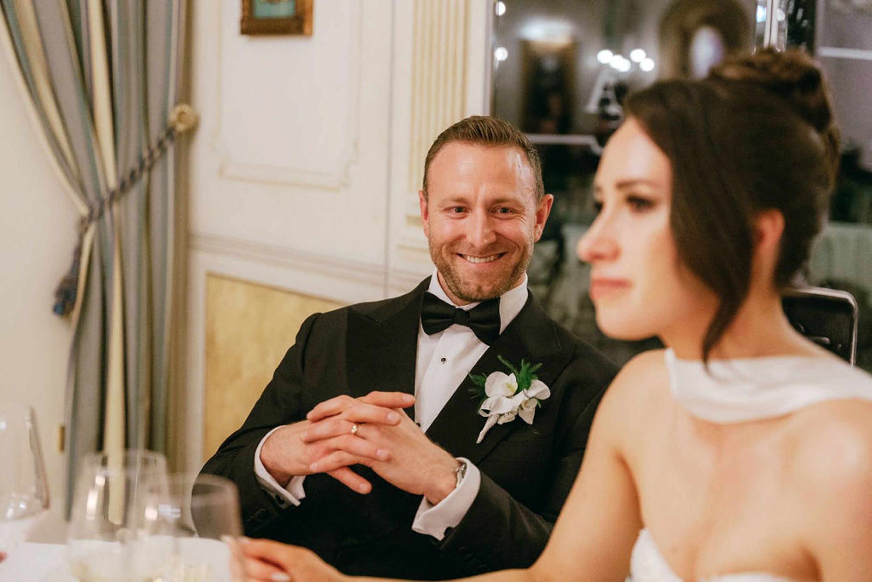 Groom smiling at the bride during dinner at an intimate wedding in Italy celebration