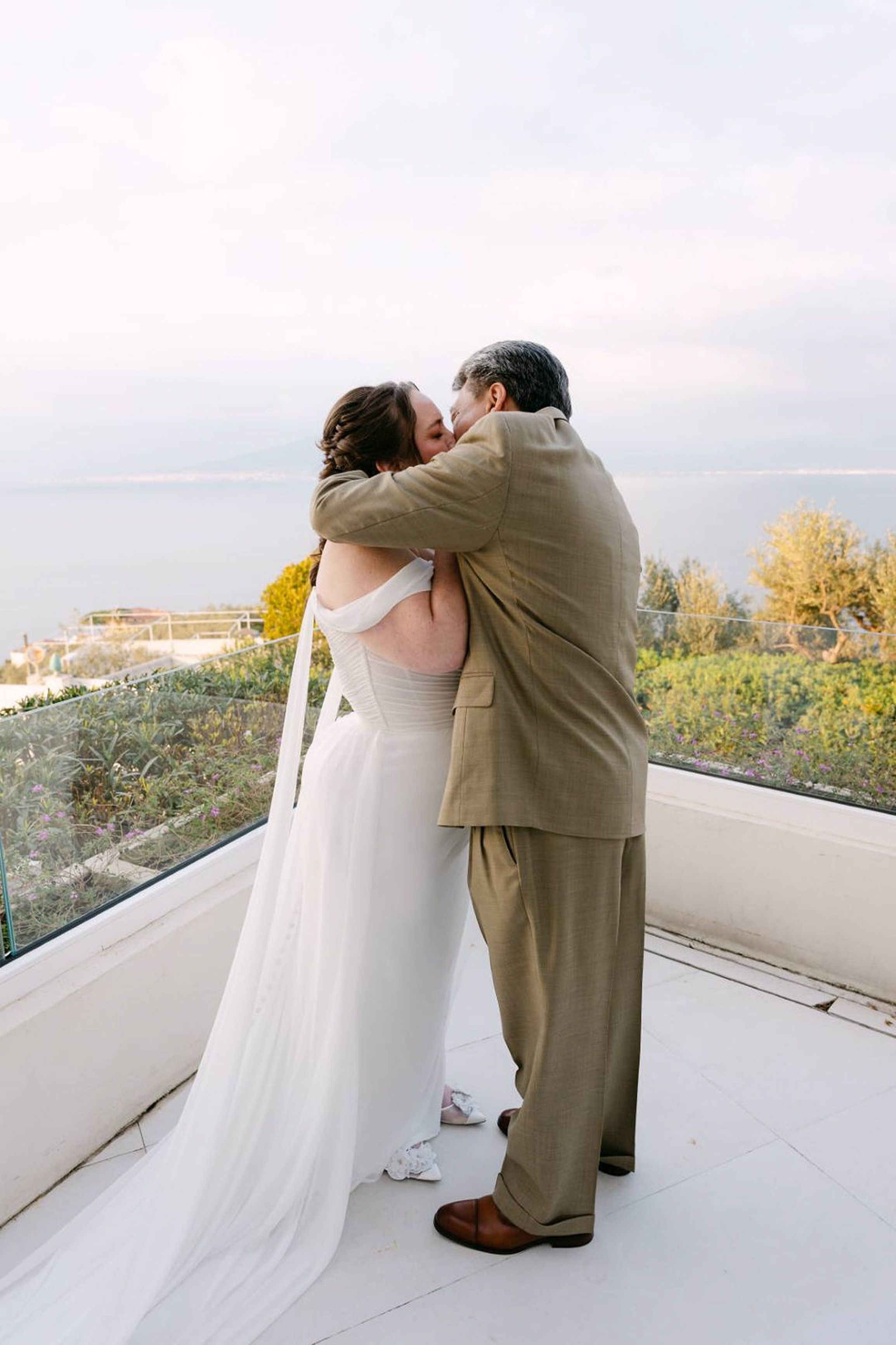 Couple kiss in golden sunset light after an intimate wedding in Italy