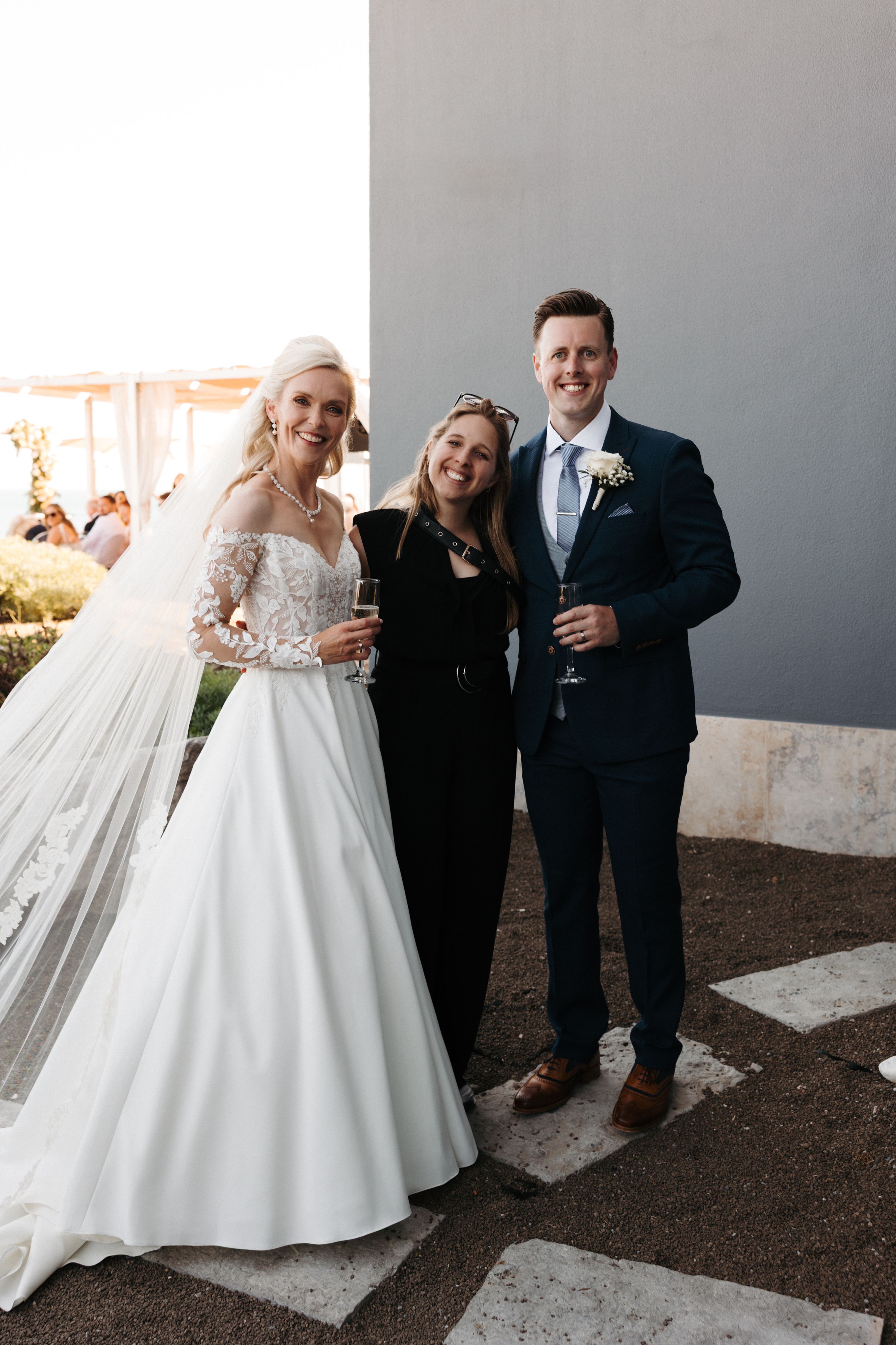 Bride and groom with their local planner after the ceremony of their small wedding in Portugal