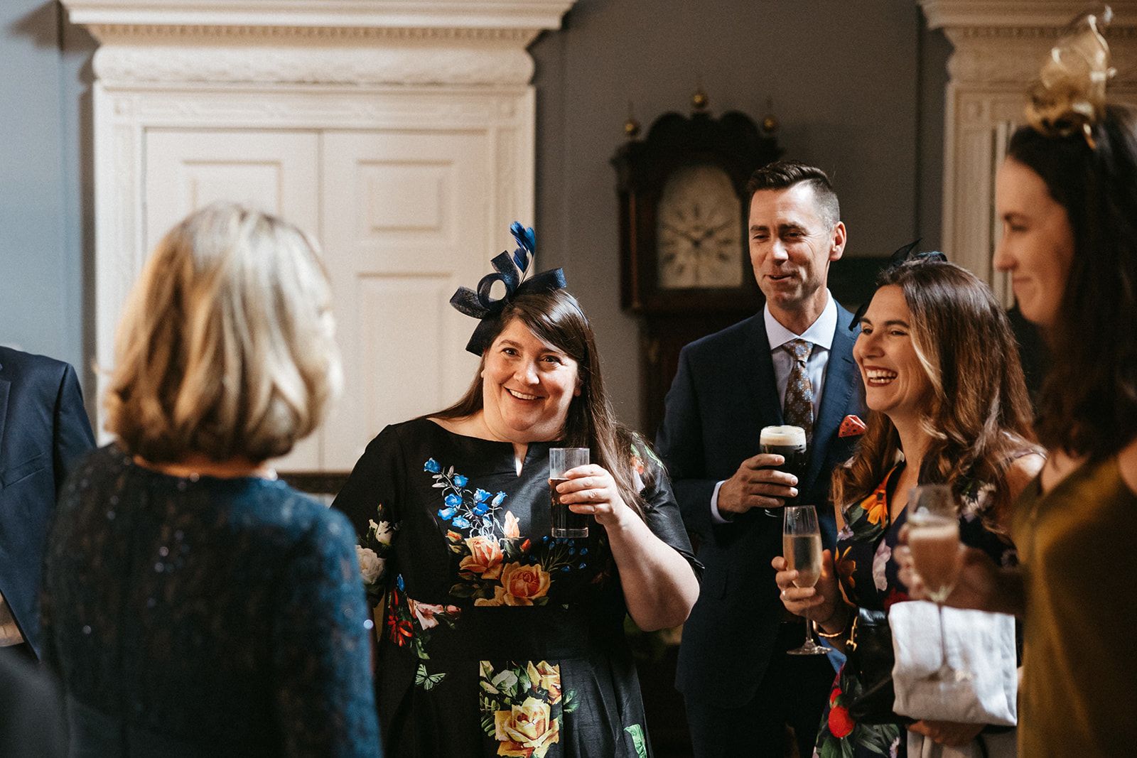 Wedding guests talk and joyfully mingle during the reception of a micro wedding in Ireland