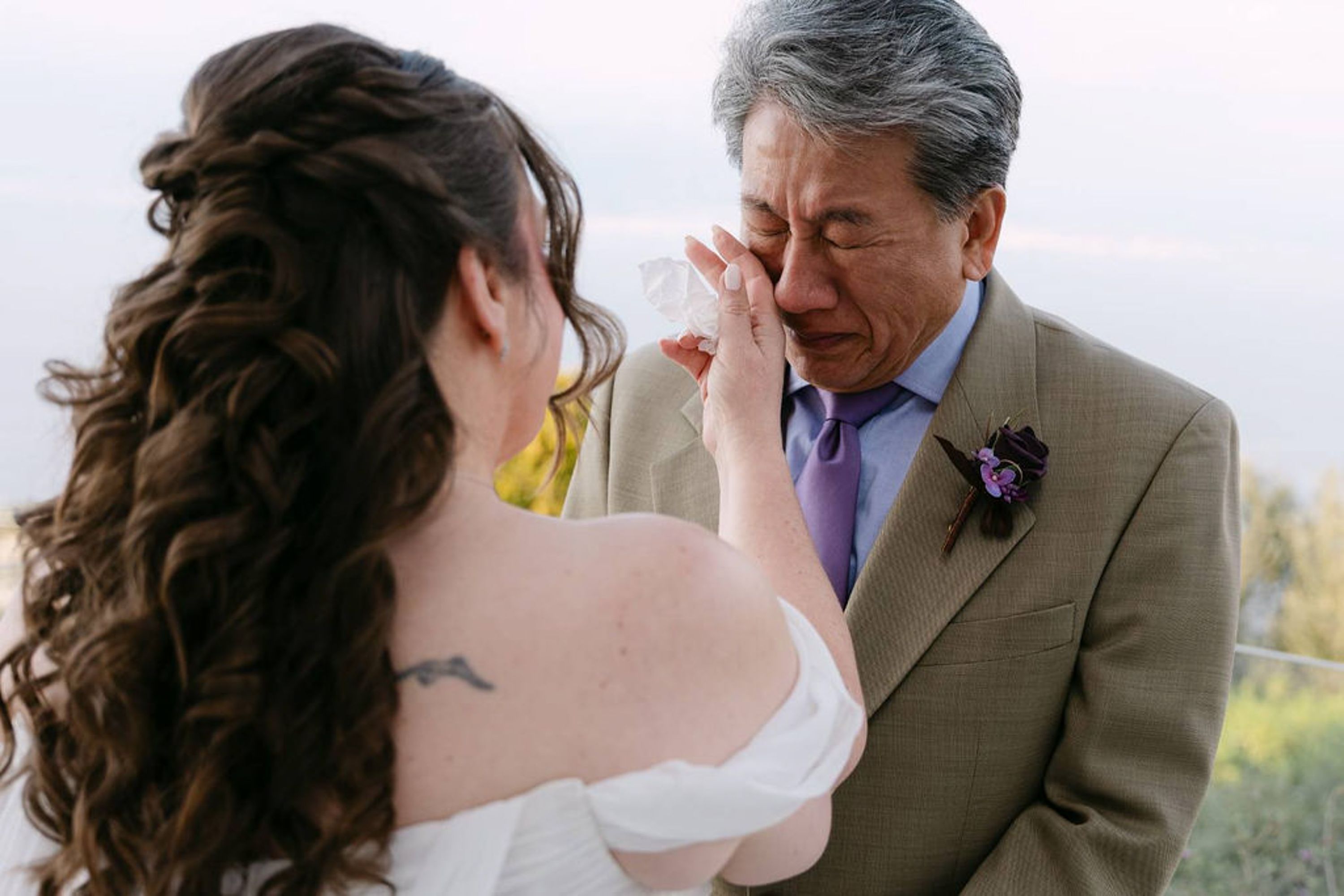 Bride wipes away groom's tears during a heartfelt small wedding in Italy ceremony
