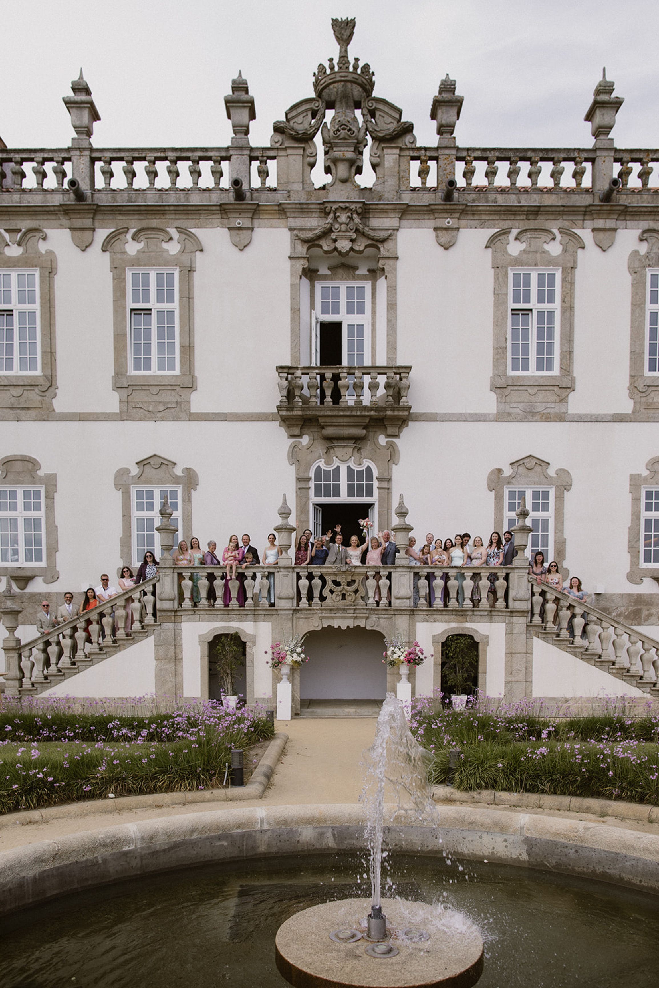 Wedding guests gathered on the manor balcony celebrating a small wedding in Portugal