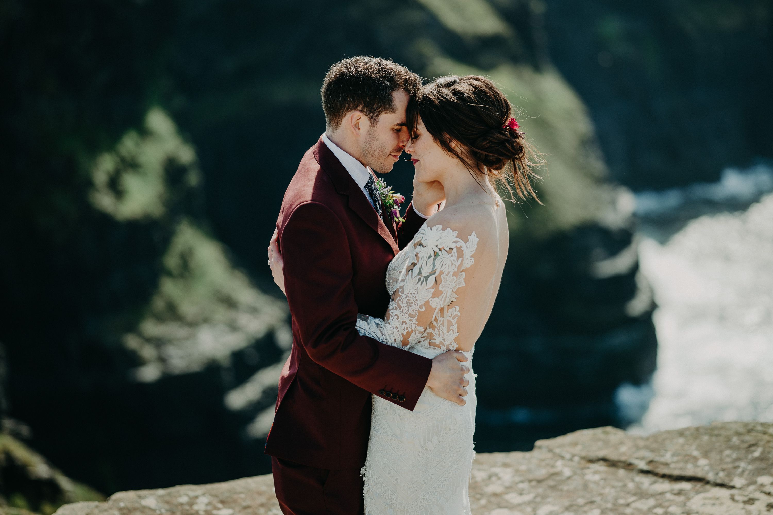 A bride and groom having a quiet moment during their cliffside intimate wedding in Ireland